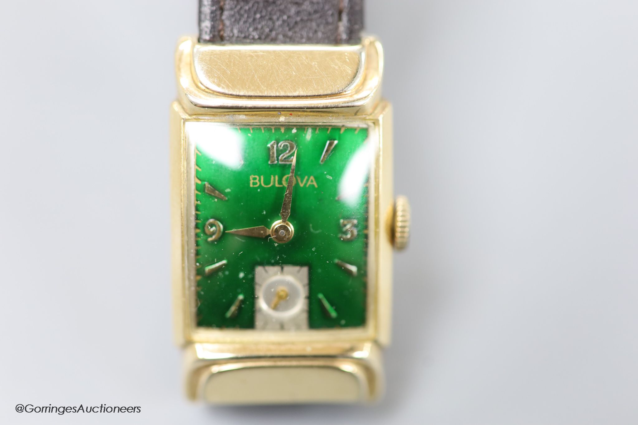 A gentleman's 1930's 10k gold filled Bulova manual wind wrist watch, with green enamel rectangular dial and subsidiary seconds, on later leather strap.